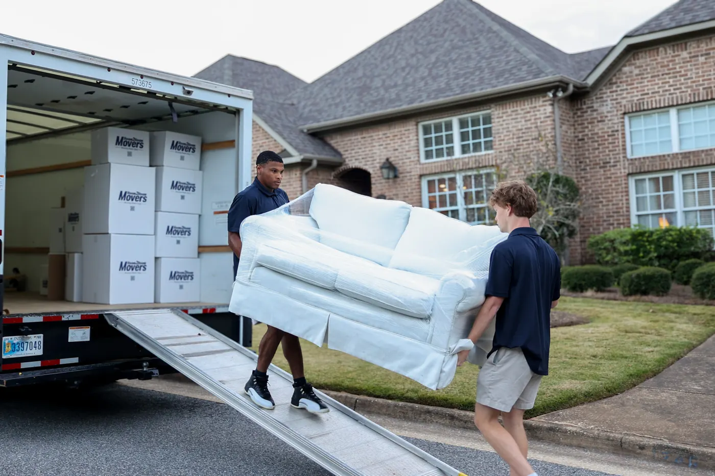 Room2Room Movers crew loading furniture into a moving truck